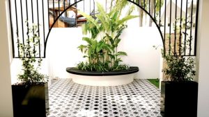Courtyard with black and white tile and planter